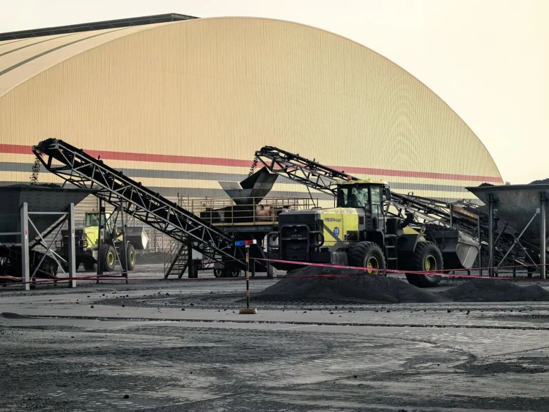 Electric wheel loader handling coal at a chemical plant yard